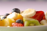 A close up shot of a bowl of fruit salad.