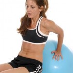 A woman using an abdominall ball.