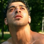 A close up shot of a muscular man's neck and face.