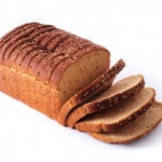 A sliced loaf of whole grain bread.