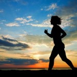 A woman running in the sunset.