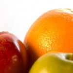 A red apple, green apple and orange.