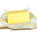 A block of butter on top of its foil wrapper.