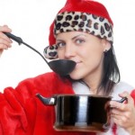 A woman cooking in a Christmas outfit.