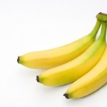 A bunch of bananas on a white background.