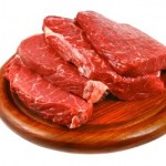 Raw fillet steak on a wooden plate.