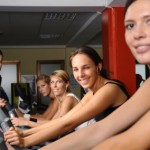 A group of women in an exercise bike class.