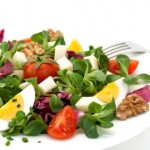 A salad with eggs and nuts.
