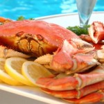 A cooked crab on a platter by a pool.