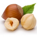 Two and a half hazelnuts on a white background.