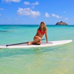A girl in a bikini on a paddleboard.