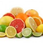 A selection of chopped and whole citrus fruits.