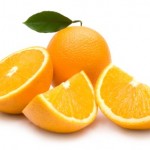 A whole and chopped orange on a white background.