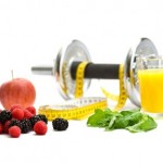 A dumbbell wrapped in a tape measure and surrounded by fruit.