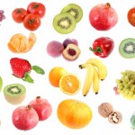 A selection of fruits, nuts and vegetables on a white background.