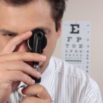 An opthamologist staring through 1 of his instruments.