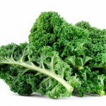 Some kale leaves on a white background.