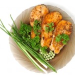 A plate of salmon with green vegetables.