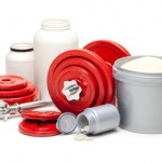 A collection of sports supplements next to a set of red dumbbells.