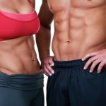 A close up shot of a couple with toned abdominal muscles.