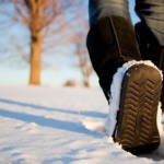 A close up shot of a person walking in winter.