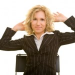 A business woman exercising in her office chair.