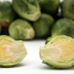 A selection of Brussels sprouts on a white background.