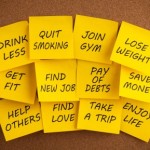 A selection of New Year goals written on yellow post it notes.