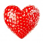 A red heart shaped strawberry.