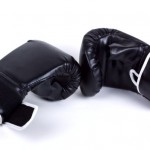 A pair of black boxing gloves on a white background.