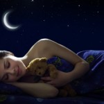 A girl sleeping with a teddy bear.