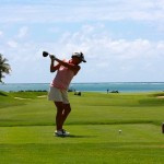 A woman playing golf.