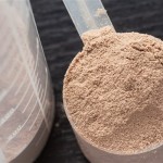 A scoop of chocolate flavoured protein powder.